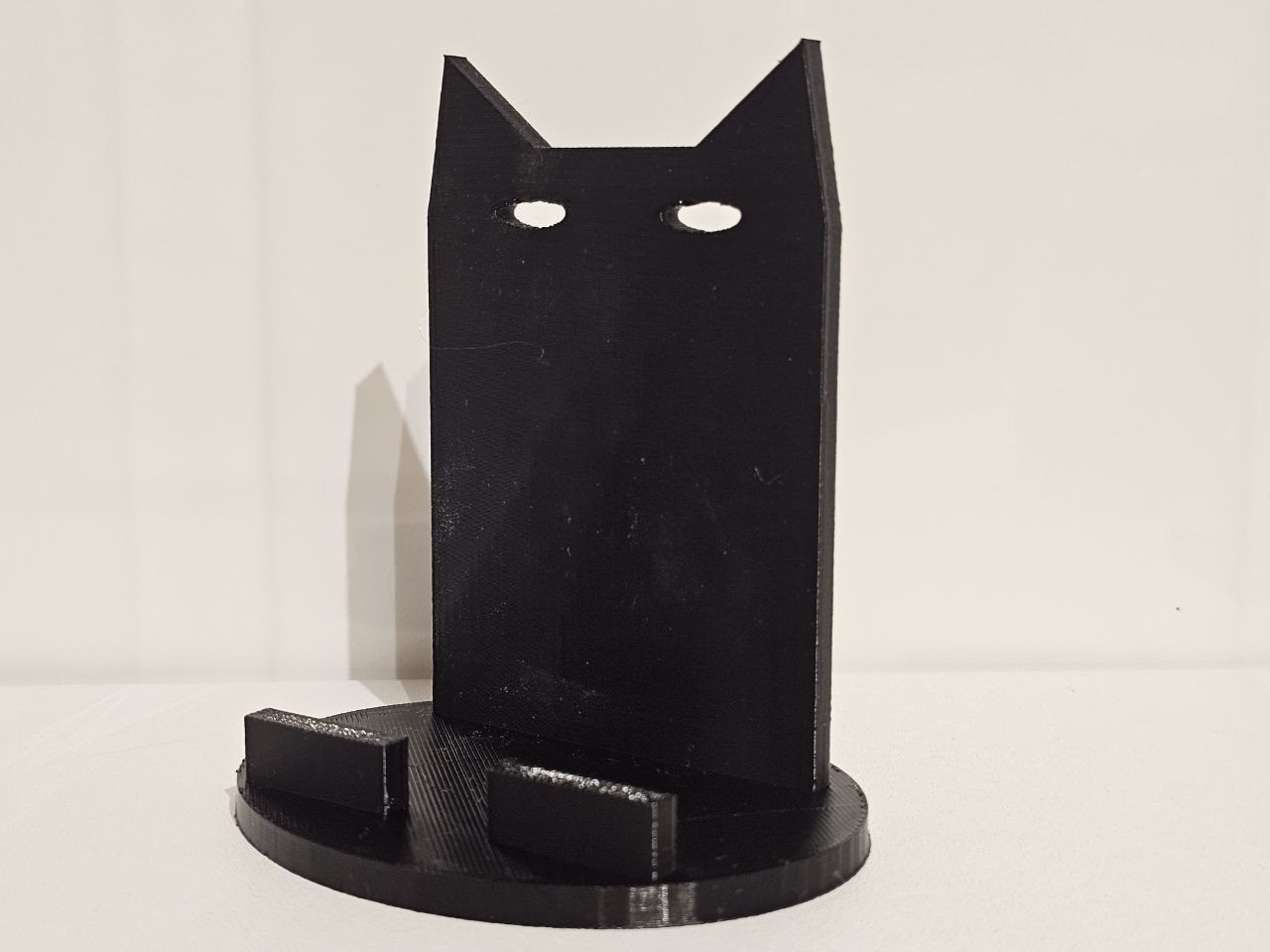 Black cat — desk phone stand